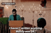 a man is giving a speech at a podium and says i haven 't written anything manny was 24 .