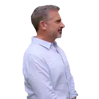 a man with gray hair and a beard is wearing a blue shirt