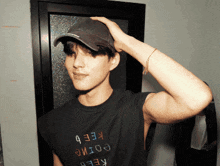 a man wearing a hat and a shirt that says keeb