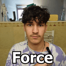 a man wearing a purple tie dye shirt has the word force written on his chest