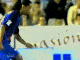 a pixelated image of a soccer player in front of a sign that says " canal + "