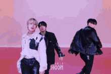 a group of young men are dancing in front of a pink background that says ' hoom '