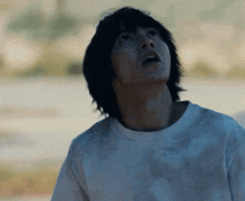 a man in a white shirt is looking up with a surprised look on his face