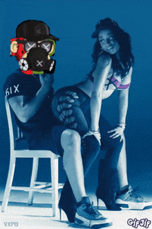 a man wearing a gas mask sits next to a woman