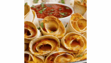 a close up of a plate of food with a bowl of salsa on the side