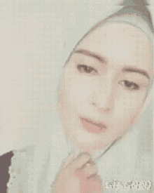 a close up of a woman wearing a hijab