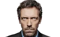 a man with a beard and blue eyes is making a serious face .