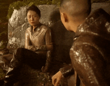 a woman sits next to a man in a video game