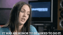 a woman says " it was an honor to be asked to do it " in front of a monitor