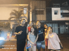 a group of people standing in front of a building with the date 2025/01/01 at the bottom