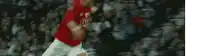 a blurry picture of a soccer player in a red shirt with the word united on it