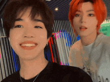 a man with red hair is standing next to another man with brown hair
