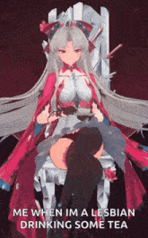 a girl in a red dress is sitting on a chair drinking tea .