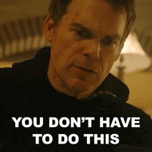 a man says " you don 't have to do this " while looking at the camera