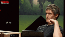 a man sitting in front of a screen that says dungeons & dragons & adventures
