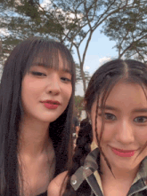 two girls are posing for a picture and one has a piercing in her forehead