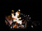 a man is riding a motorcycle in the dark with a yellow light behind him