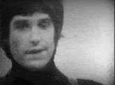 a black and white photo of a man 's face