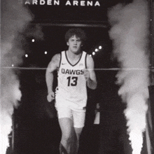 a black and white photo of a basketball player wearing a dawgs 13 jersey