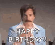 a man in a blue suit with a mustache is saying happy birthday !
