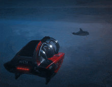 a red and black avisa submarine floating in the ocean