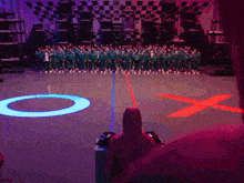 a large group of people are standing in a circle with a red x in the middle