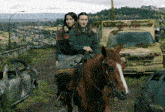 two women riding a horse in front of a seattle ems truck