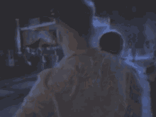 a man in a suit and tie is standing in a dark room