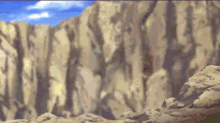 a cliff with a blue sky and clouds in the background
