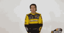 a man wearing a yellow menards shirt is waving his hand