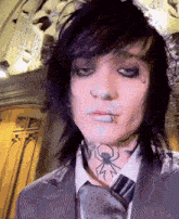 a man with a spider tattoo on his neck