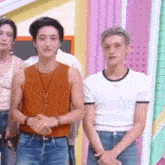 a group of young men are standing next to each other on a stage .