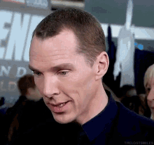 a close up of a man 's face with a sign in the background that says ' end '