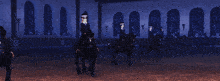 a group of people are riding black horses in a dark room