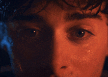 a close up of a person 's face with a red eye