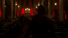 a silhouette of a person in a dark room with red lights