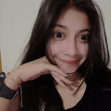 a woman wearing a watch and a choker looks at the camera