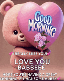 a teddy bear holding a pink heart that says good morning on it