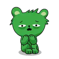 a green teddy bear with a sad face is sitting down