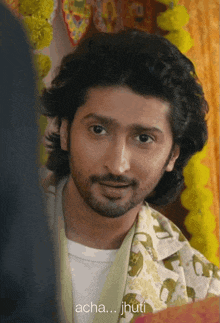 a man with long hair and a beard is talking to another man with the words " acha ... jhuti " next to him