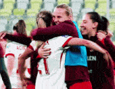 a soccer player wearing number 1 is hugging another player