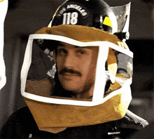 a man wearing a helmet with the number 118
