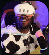 a man wearing a virtual reality headset and a cow print hoodie