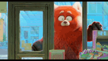 a red bear is standing in front of a store window with a sign that says express