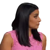 a woman in a pink lace top is making a face