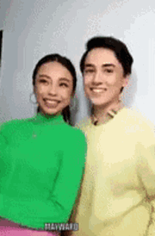 a man and a woman are posing for a picture together .