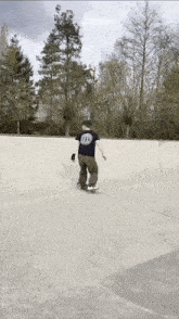 a person riding a skateboard in a skate park wearing a t-shirt that says tnl
