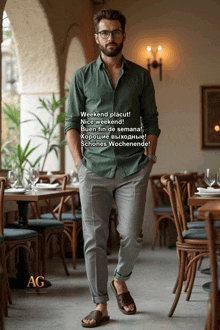 a man in a green shirt and gray pants is standing in a restaurant