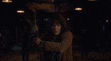 a woman is holding a large axe in her hand
