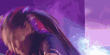 a close up of a woman 's face with a purple background